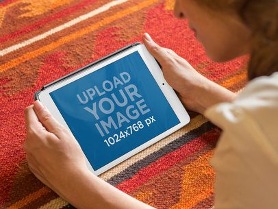Girl Using White iPad On the Carpet