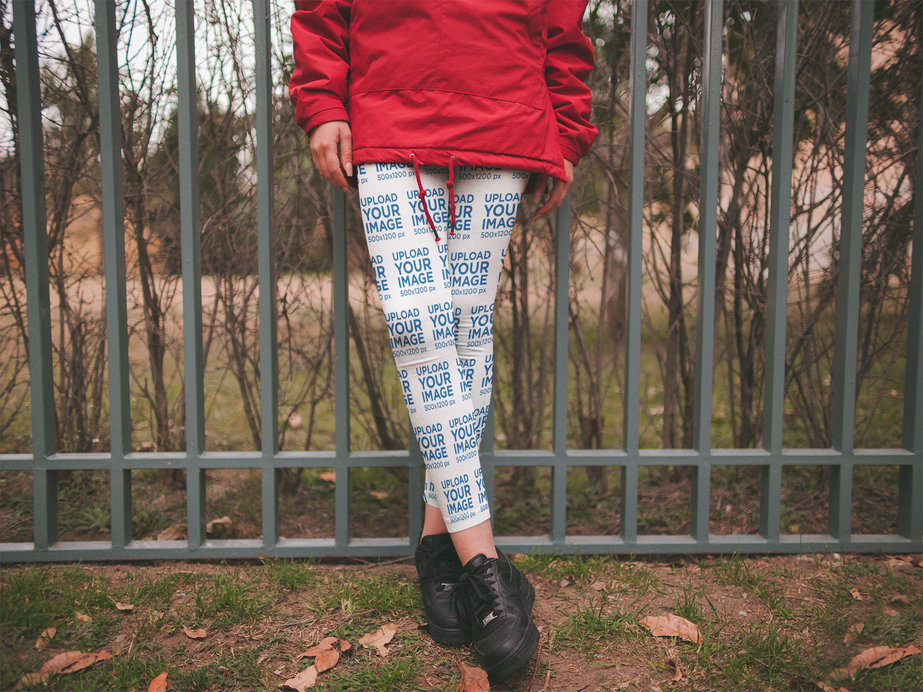 Leggings Mockup of a Woman Leaning Against an Iron Fence