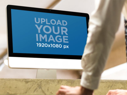 Mockup of a Man Working With an iMac m35839