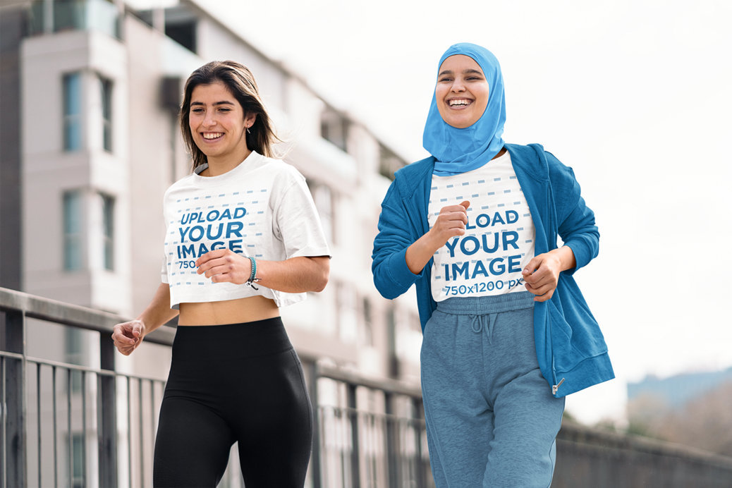 Crop Top and T-Shirt Mockup Featuring Two Cheerful Women Running in the Street
