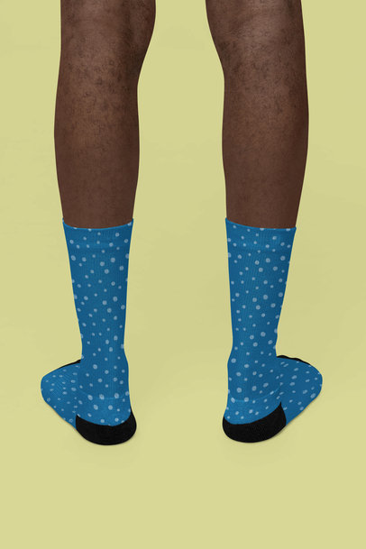 Mockup of a Pair of Sublimated Socks Featuring a Man in a Studio