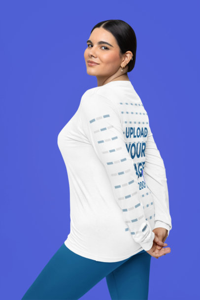 Mockup of a Smiling Woman Posing in a Studio Wearing a Long Sleeve Tee 