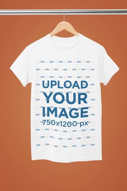 Mockup of a Rounded-Neck Gildan T-Shirt Hanging From a Steel Bar