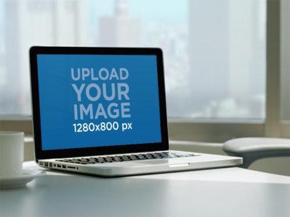 Mockup of a MacBook Placed on a Desk Near a Coffee Cup m35907