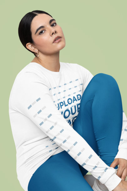 Bella Canvas Long-Sleeve Tee Mockup Featuring a Serious Woman Sitting in a Studio