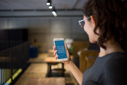 Mockup of a Woman Using a Rose Gold iPhone 7 Plus 