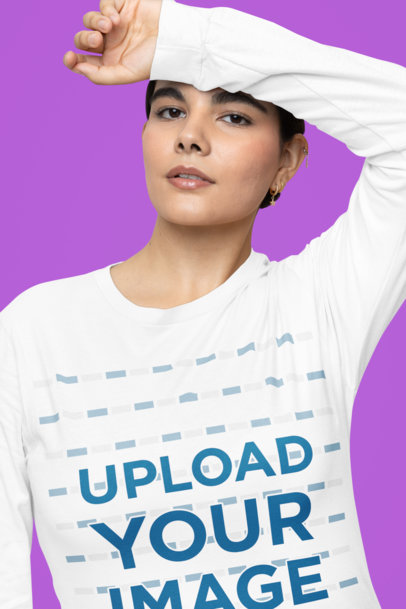 Mockup of a Woman Posing in a Studio Wearing a Long Sleeve Bella Canvas Tee