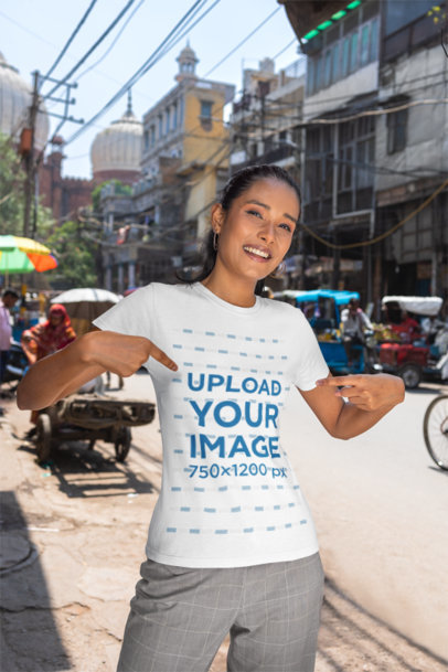 Mockup of a Smiling Woman on a Street Pointing at Her Crewneck Gildan T-Shirt