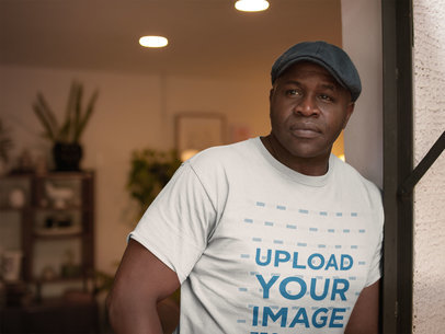 Mockup of a Senior Man Wearing a T-Shirt and a Beret at Home