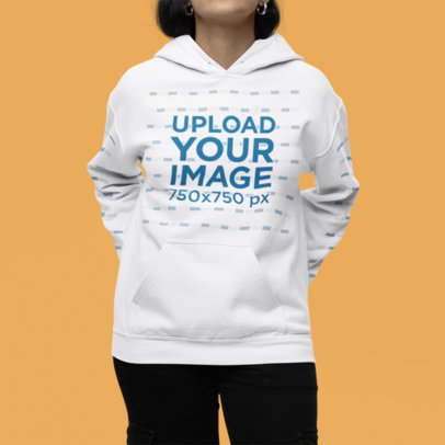 Mockup of a Woman Wearing a Gildan Pullover Hoodie in a Studio