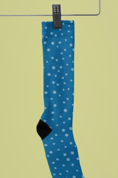 Mockup of a Sublimated Sock Hanging Against a Customizable Background