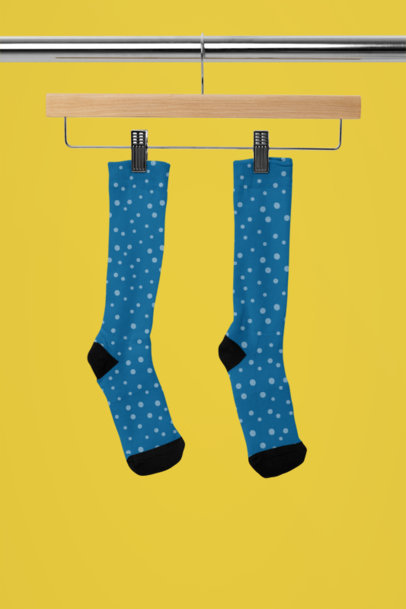 Mockup of a Pair of Sublimated Socks Placed on a Wooden Hanger