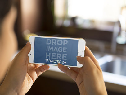 Woman Holding Gold iPhone 6 at the Kitchen