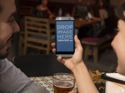 Young Couple Viewing HTC One M8 at a Restaurant