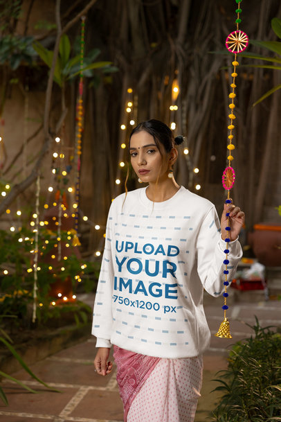 Mockup of a Woman Wearing a Round-Neck Sweatshirt in a Diwali-Decorated Patio m35975