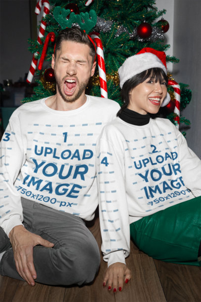 Gildan Sweatshirt Mockup Featuring a Joyful Couple Celebrating Christmas by a Tree