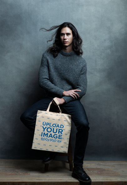 Tote Bag Mockup of a Serious Man Posing for an Editorial Photoshoot