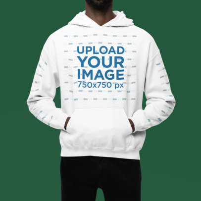 Gildan Pullover Hoodie Mockup Featuring a Cropped-Face Man Posing in a Studio With a Colorful Background