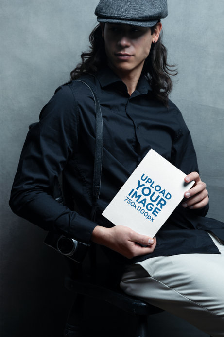 Mockup of a Long-Haired Model Holding a Book in a Studio