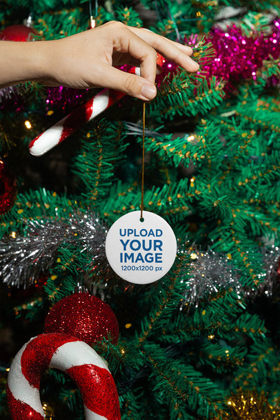 Christmas-Themed Mockup of a Person Holding a Ceramic Ornament m35938