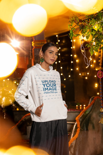 Gildan Hoodie Mockup of a Woman Standing in a Room Decorated for Diwali
