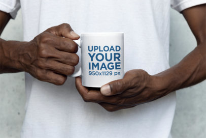 Mockup of a Man Holding an 11 oz Coffee Mug with Both Hands m35748