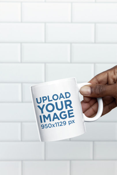 Mockup of a Man Holding an 11 Oz Coffee Mug Against a White Wall m35749