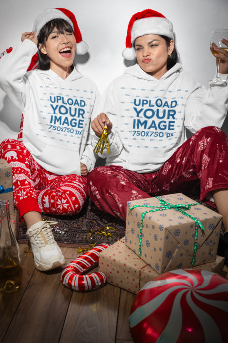 Gildan Hoodie Mockup Featuring Two Friends Wearing Santa Hats and Celebrating Xmas 