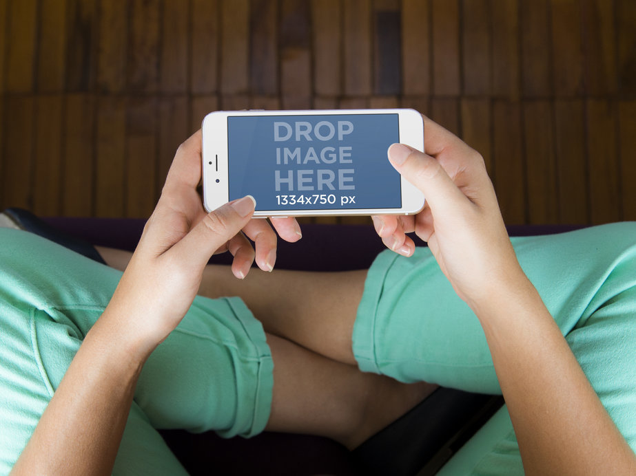 Mockup Generator of Woman Sitting on Yoga Mat Holding iPhone 6