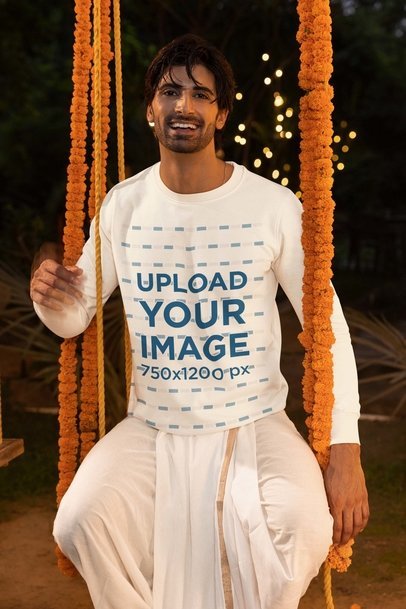 Diwali-Themed Sweatshirt Mockup of a Happy Man Sitting on a Swing Decorated with Flowers m35987