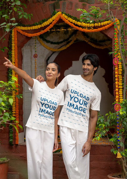 Gildan T-Shirt Mockup Featuring a Woman and a Man Pointing at Something in a Diwali Celebration