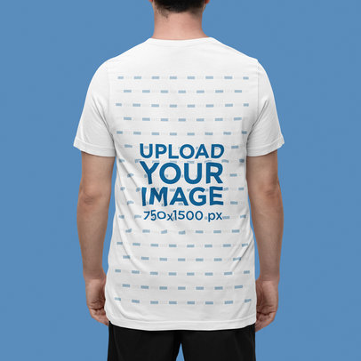 Back-View Mockup Featuring a Man Standing in a Studio Wearing a Bella Canvas Tee