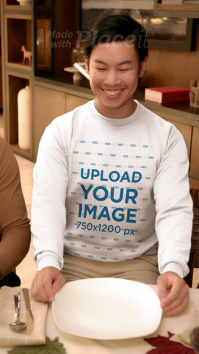 Gildan Sweatshirt Video Featuring a Smiling Man Praying in a Thanksgiving Dinner