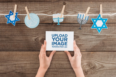 Hanukkah-Themed Mockup Featuring a Person Holding a Flyer m35179 r-el2