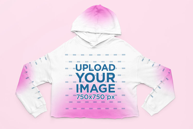 Mockup of a Cropped Hoodie with Customizable Sleeves Flat Laid over a Surface 