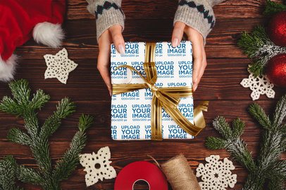 Wrapping Paper Mockup Featuring a Woman Holding a Gift Against a Christmas-Themed Setting
