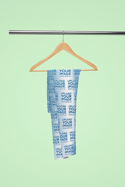 Mockup Featuring a Pair of Gradient-Colored Leggings Hanging From a Steel Bar