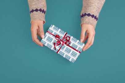 Mockup of a Woman Holding a Small Present Covered in Wrapping Paper m35521 r-el2