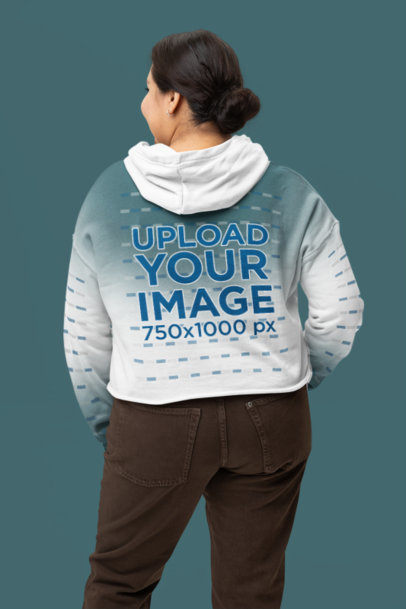 Back-View Mockup of a Woman in a Crop Top Bella Canvas Hoodie with Customizable Sleeves