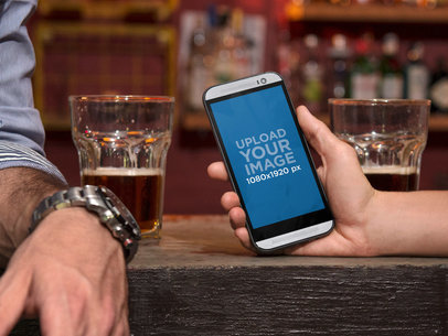 Mockup Template of Couple Having Drinks and Using HTC One M8
