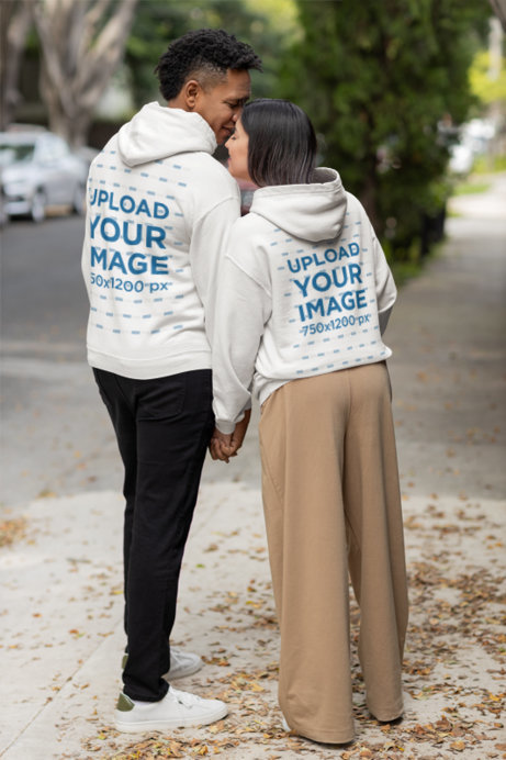 Back-View Gildan Hoodie Mockup Featuring a Cute Couple Holding Hands