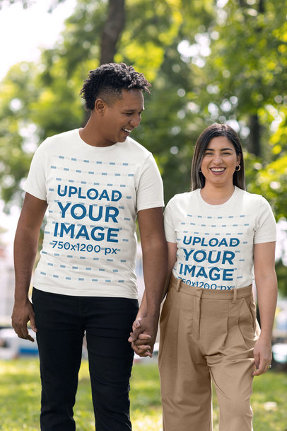 Bella Canvas T-Shirt Mockup of a Smiling Couple Holding Hands at a Park