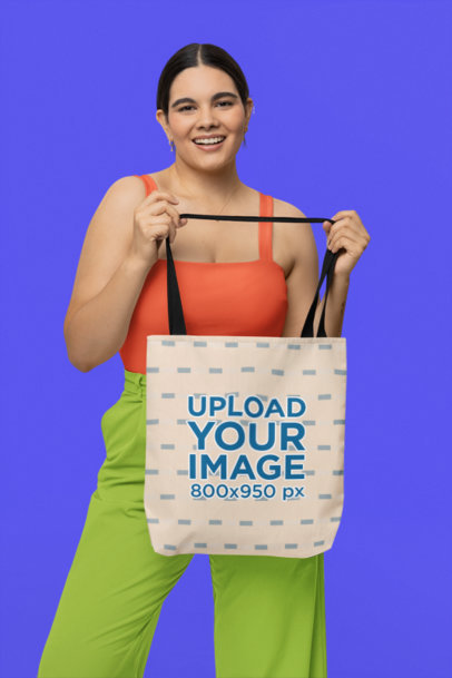 Mockup of a Smiling Woman Showing Off Her New Tote Bag 