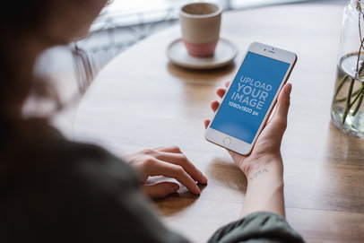 Rose Gold iPhone 7 Plus Mockup Featuring a Woman at a Coffee Shop