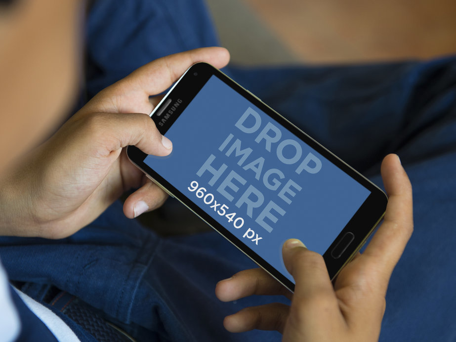 Mockup Template of Boy Gaming with Black Samsung Galaxy
