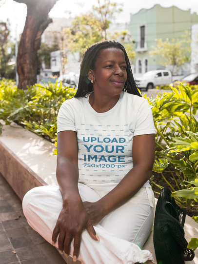 Mockup of a Lady Wearing a T-Shirt at a Park