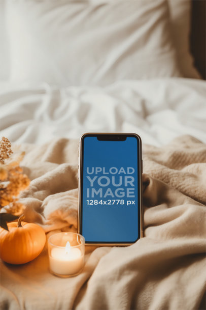Mockup of an iPhone Placed on a Cozy Bed Decorated with Candles