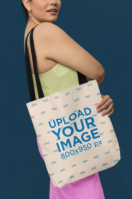 Mockup of a Woman Carrying a Sublimated Tote Bag over Her Shoulder