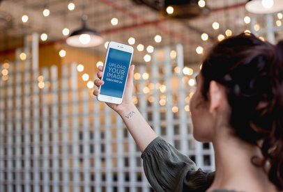 Silver iPhone 8 Plus Mockup Featuring a Woman Taking a Selfie