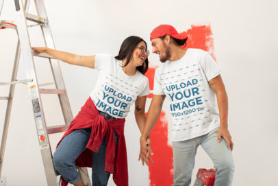 Round-Neck T-Shirt Mockup of a Smiling Couple Painting a Wall